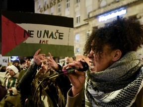 A woman shouts pro-Palestinian and anti-Israel slogans on a megaphone during a rally during a rally to express support to Palestinian people in downtown Zagreb, on January 13, 2024. Hamas's unprecedented attack on Israel on October 7, 2023, which left about 1,140 dead in Israel, mostly civilians, according to an AFP tally based on official figures, and saw 250 hostages dragged back into Gaza, sparked the war which is still raging in the besieged Gaza Strip. After almost 100 days of war, at least 23,357 people have been killed in Gaza, the majority of them women and children, according to the Hamas health ministry.