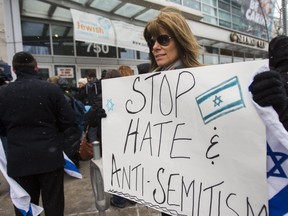 In this March 13, 2017 file photo, a woman attends a rally speaking out against anti-Semitism in Canadian society in front of the Miles Nadal Jewish Community Centre at Bloor St. and Spadina Ave. in Toronto.