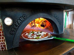 A pizza in a wood fired oven