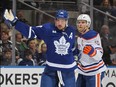 Connor McDavid of the Edmonton Oilers holds up Auston Matthews of the Toronto Maple Leafs during their game at Scotiabank Arena on March 11, 2023.