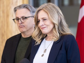 Alberta NDP Leader Rachel Notley announces she is stepping down as leader of the party as her husband Lou Arab listens on Tuesday, Jan. 16, 2024 in Edmonton.