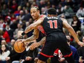 Chicago Bulls forward DeMar DeRozan (11) drives towards the net while guarded by Toronto Raptors forward Bruce Brown (11) during first half NBA basketball action in Toronto on Thursday, January 18, 2024.