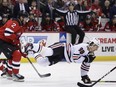 Chicago Blackhawks center Connor Bedard falls to the ice after being checked by New Jersey Devils defenseman Brendan Smith during the first period of an NHL hockey game Friday, Jan. 5, 2024, in Newark, N.J.