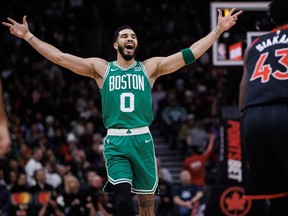 Celtics' Jayson Tatum reacts to a team basket against the Toronto Raptors during the first half at Scotiabank Arena on Tuesday.