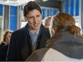 Prime Minister Justin Trudeau speaks to a community member at a housing announcement in Guelph, Ontario on Friday January 12, 2024.