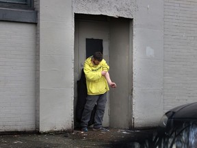 A man uses drugs on Dunlevy Avenue on Jan. 24, 2024, the same day the B.C. Coroners Service announced there were 2,511 suspected unregulated toxic drug deaths last year.