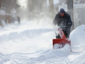 Person uses a snow blower