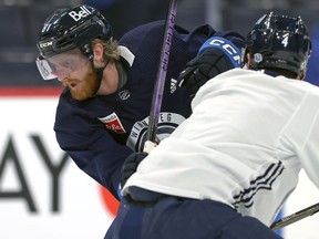 Kyle Connor (left) is defended by Neal Pionk during Winnipeg Jets practice