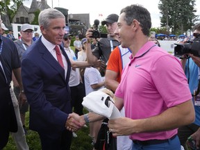 Rory McIlroy shakes hands with PGA commissioner Jay Monahan after winning the Canadian Open in 2022.