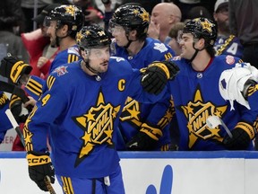 NHL All-Star Team Matthews Captain, forward Auston Matthews of the Maple Leafs, celebrates his goal against Team McDavid with teammates on the bench during the NHL All-Star Game in Toronto, Saturday, Feb. 3, 2024.