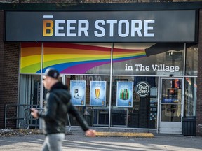A pedestrian passes a Beer Store in downtown Toronto.