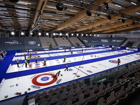 Teams test the ice during a practice session at the Scotties Tournament of Hearts in Calgary, Alta., Thursday, Feb. 18, 2021. Cardboard cut-out fans can be seen in the stands.