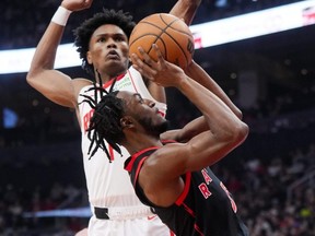 The Raptors' Immanuel Quickley (bottom) goes up for a shot against the Rockets' Amen Thompson during first half NBA Action at Scotiabank Arena in Toronto, Friday, Feb. 9, 2024.