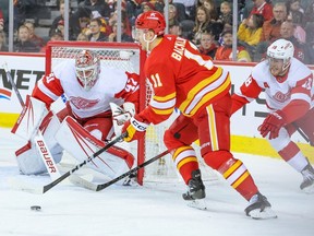 Calgary Flames forward Mikael Backlund moves the puck in front of Detroit Red Wings goalie James Reimer during NHL action at the Scotiabank Saddledome in Calgary on Saturday, February 17, 2024.