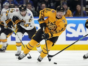 Team MacKinnon forward Sidney Crosby of the Pittsburgh Penguins, moves the puck during the NHL all-star game against Team McDavid, in Toronto, Saturday, Feb. 3, 2024.