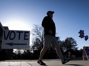A resident walks out of their voting precinct after voting on the morning of the South Carolina Republican primary at New Bridge Academy in Cayce, S.C., Saturday, Feb. 24, 2024.