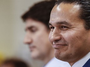 Manitoba Premier Wab Kinew, with Prime Minister Justin Trudeau, smiles at Red River College Polytechnic in Winnipeg, Thursday, Feb. 15, 2024. The Manitoba government says its fuel-tax cut is helping to keep the inflation rate low, but is not saying how long the cut will remain in place.THE CANADIAN PRESS/John Woods