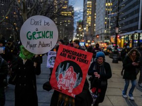 People gather in front of the New York city hall to protest against the plan to limit migrants' shelter stays to 60 days on Dec. 19, 2023.