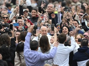 Pope Francis waves to the crowd from the popemobile after the Easter Mass as part of the Holy Week celebrations, at St Peter's square in the Vatican on March 31, 2024.