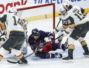 Winnipeg Jets' Tyler Toffoli (73) gets hit by a shot in front of Vegas Golden Knights goaltender Logan Thompson (36) during first period NHL action in Winnipeg on Thursday.