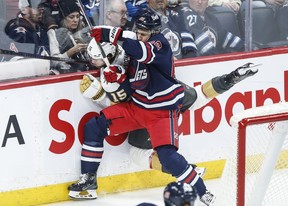 Winnipeg Jets' Nino Niederreiter (62) and Vegas Golden Knights' Noah Hanifin (15) collide during third first NHL action in Winnipeg on Thursday, March 28, 2024.