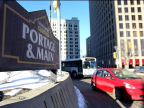 Traffic moves through the intersection of Main Street at Portage Avenue
