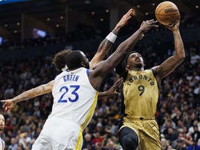 Raptors' RJ Barrett, right, drives against Draymond Green of the Warriors during first half NBA action at Scotiabank Arena in Toronto, Friday, March 1, 2024.