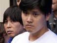 Ippei Mizuhara stands next to Japanese baseball star Shohei Ohtani and translates during an interview at Dodger Stadium on Feb. 3, 2024.