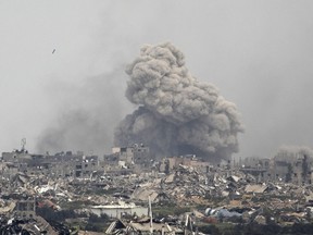 Smoke rises over the Gaza Strip after an Israel bombardment as seen from a position on the Israeli side of the border on March 17, 2024.