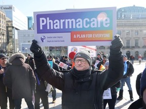 A person holds a pharmacare sign at a health-care rally on Parliament Hill in Ottawa on Tuesday, Feb. 13, 2024.
