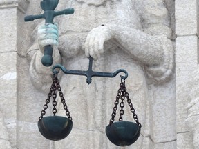 A Lady Justice statue on the law courts building in Winnipeg