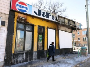 A woman walks past a grocery store on Sargent Avenue