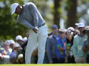 Tiger Woods hits his tee shot on the fourth hole during second round at the Masters golf tournament.