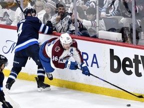 Colorado Avalanche's Mikko Rantanen is tripped up by Winnipeg Jets' Neal Pionk during the third period in Game 2.