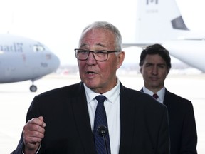 Defence Minister Bill Blair, front centre, and Prime Minister Justin Trudeau hold a press conference announcing Canada's new defence policy at CFB Trenton, in Trenton, Ont., on April 8.