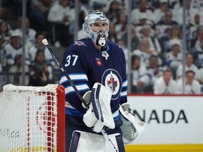 Connor Hellebuyck of Winnipeg Jets looks on during action against the Colorado Avalanche.