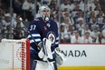 Connor Hellebuyck of Winnipeg Jets looks on during action against the Colorado Avalanche.