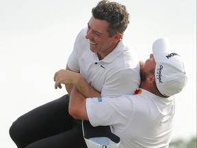 Rory McIlroy, left, of Northern Ireland and Shane Lowry of Ireland celebrate on the 18th green after winning the final round of the Zurich Classic of New Orleans at TPC Louisiana on Sunday, April 28, 2024, in Avondale, La.