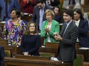 Deputy Prime Minister and Minister of Finance Chrystia Freeland receives applause from Prime Minister Justin Trudeau, right, and other members of the Liberal party after she presented the federal budget in the House of Commons in Ottawa on Tuesday, April 16, 2024.