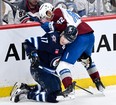 Colorado Avalanche's Caleb Jones (82) ties up Winnipeg Jets' Adam Lowry (17) during the first period in Game 2 of their NHL hockey Stanley Cup first-round playoff series in Winnipeg.