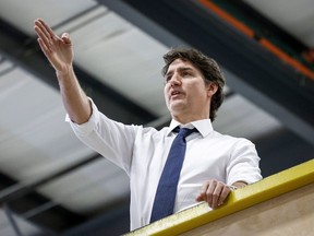 Prime Minister Justin Trudeau tours a modular home construction facility before making a housing announcement in Calgary, Alta., Friday, April 5, 2024. THE CANADIAN PRESS/Jeff McIntosh