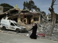 A woman stands in front of the house where two women from the same family were killed on April 23 in a reported Israeli strike in the southern Lebanese village of Hanin, on April 25, 2024.