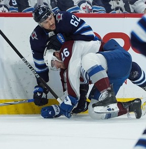 WINNIPEG, CANADA - APRIL 30: Sean Walker #26 of the Colorado Avalanche is tied up by Nino Niederreiter #62 of the Winnipeg Jets in Game Five of the First Round of the 2024 Stanley Cup Playoffs at Canada Life Centre on April 30, 2024, in Winnipeg, Canada. (Photo by David Lipnowski/Getty Images)