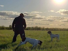 Jeffrey Barrett with his dogs in an open field