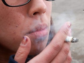 A teen smoking near a school