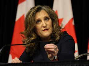 Federal Finance Minister Chrystia Freeland is pictured speaking with reporters in Ottawa on Tuesday inside a budget lockup.