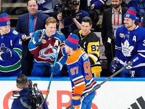 Edmonton Oilers' Connor McDavid is congratulated by Vancouver Canucks' Elias Pettersson, left to right, Colorado Avalanche's Nathan MacKinnon, Pittsburgh Penguins' Sidney Crosby and Toronto Maple Leafs' Auston Matthews after winning the NHL All-Star skills competition in Toronto, Friday, Feb. 2, 2024.