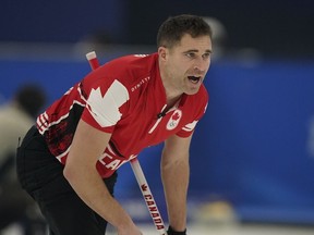 John Morris, of Canada, yells to his teammate after he throws a rock during the mixed doubles curling match against the Czech Republic at the Beijing Winter Olympics on Monday, Feb. 7, 2022, in Beijing. A group that includes two-time Olympic gold medal curler Morris and former NFL player Jared Allen has purchased the Grand Slam of Curling tour from Sportsnet.