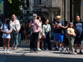 Pedestrians cross a street in downtown Vancouver, B.C.