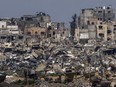 Destroyed buildings stand inside Gaza Strip, as seen from southern Israel, Tuesday, March 19, 2024.